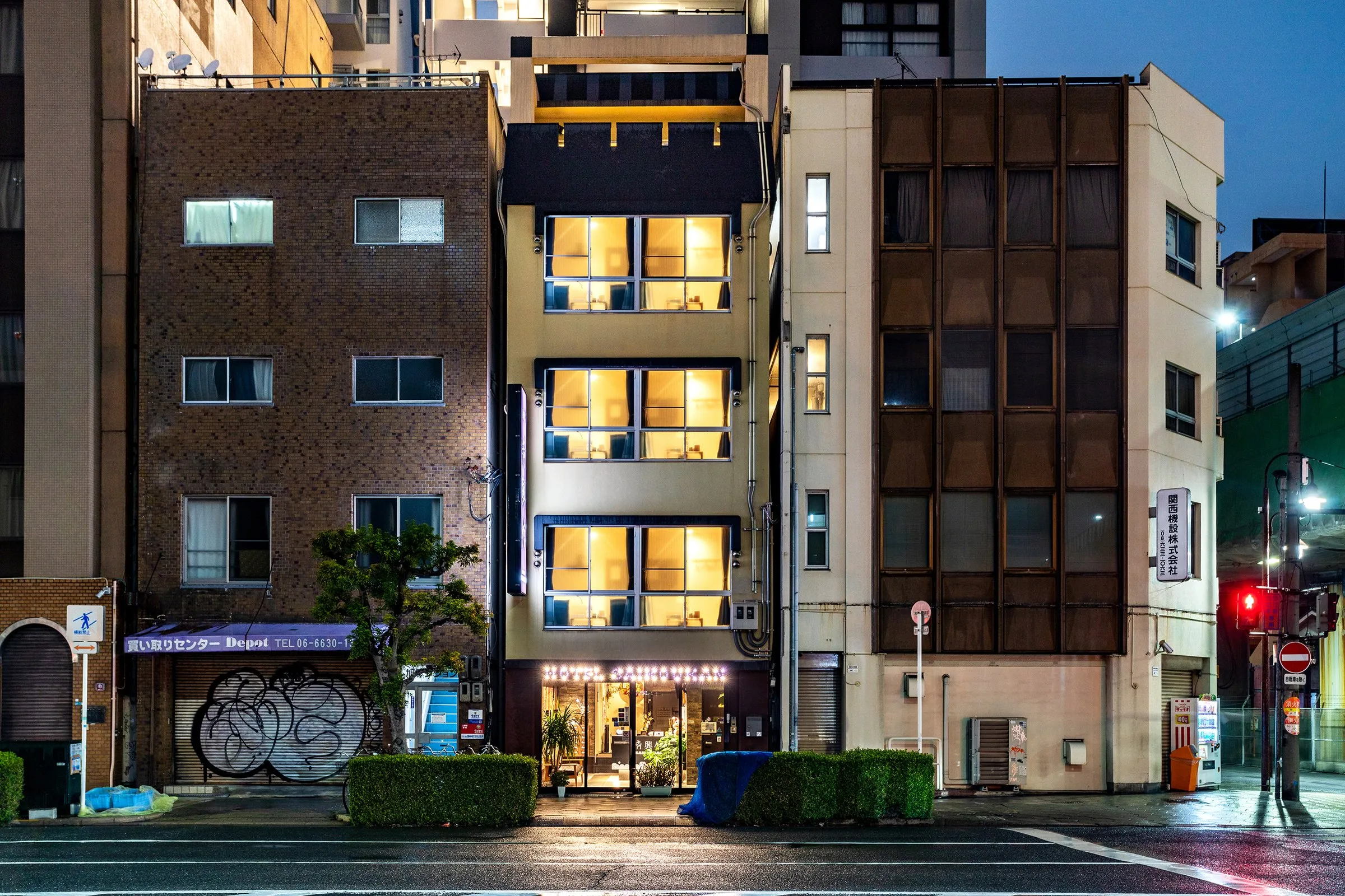 The five-storey inn at night with every window lit