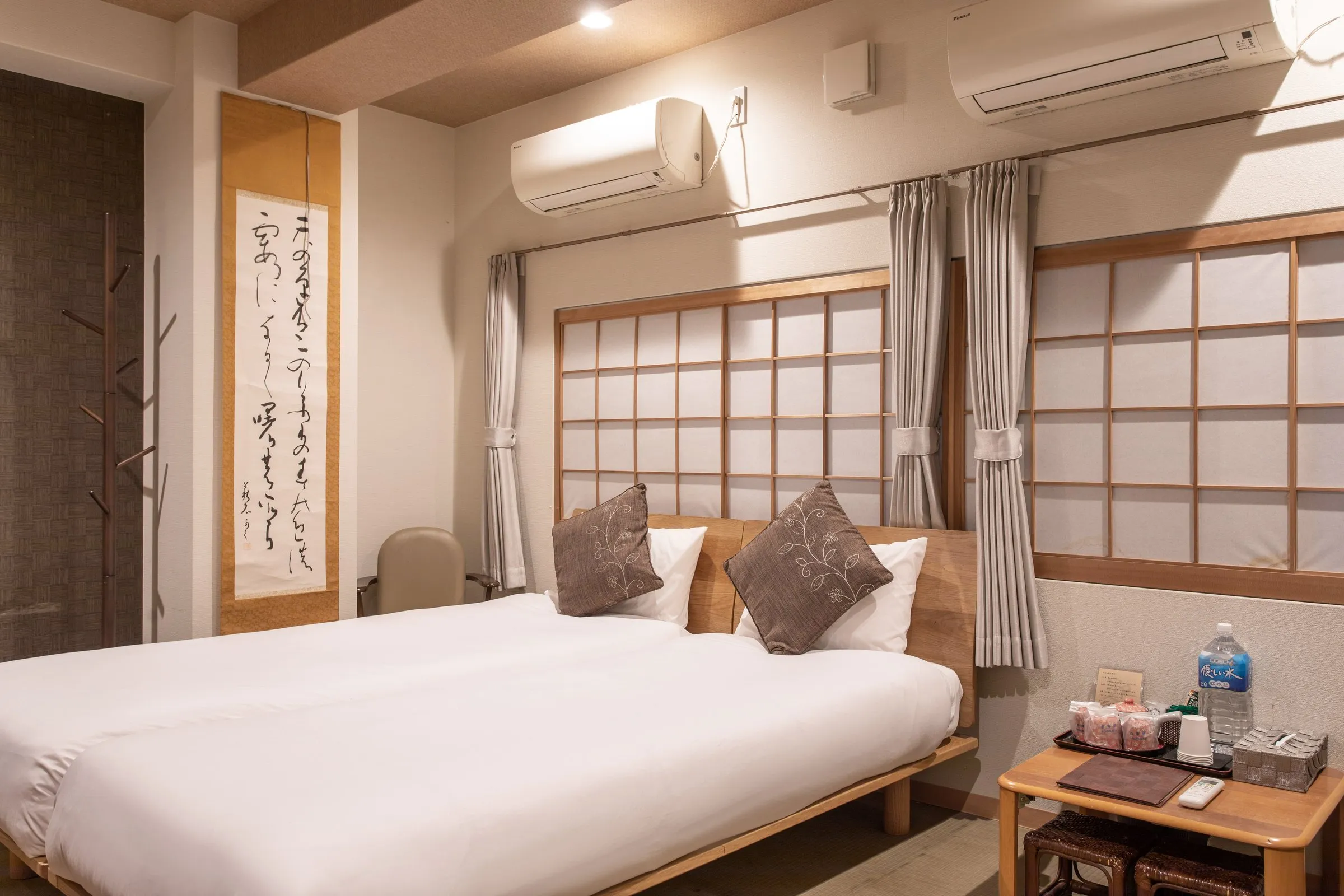 Twin room with shoji screens and a calligraphy scroll