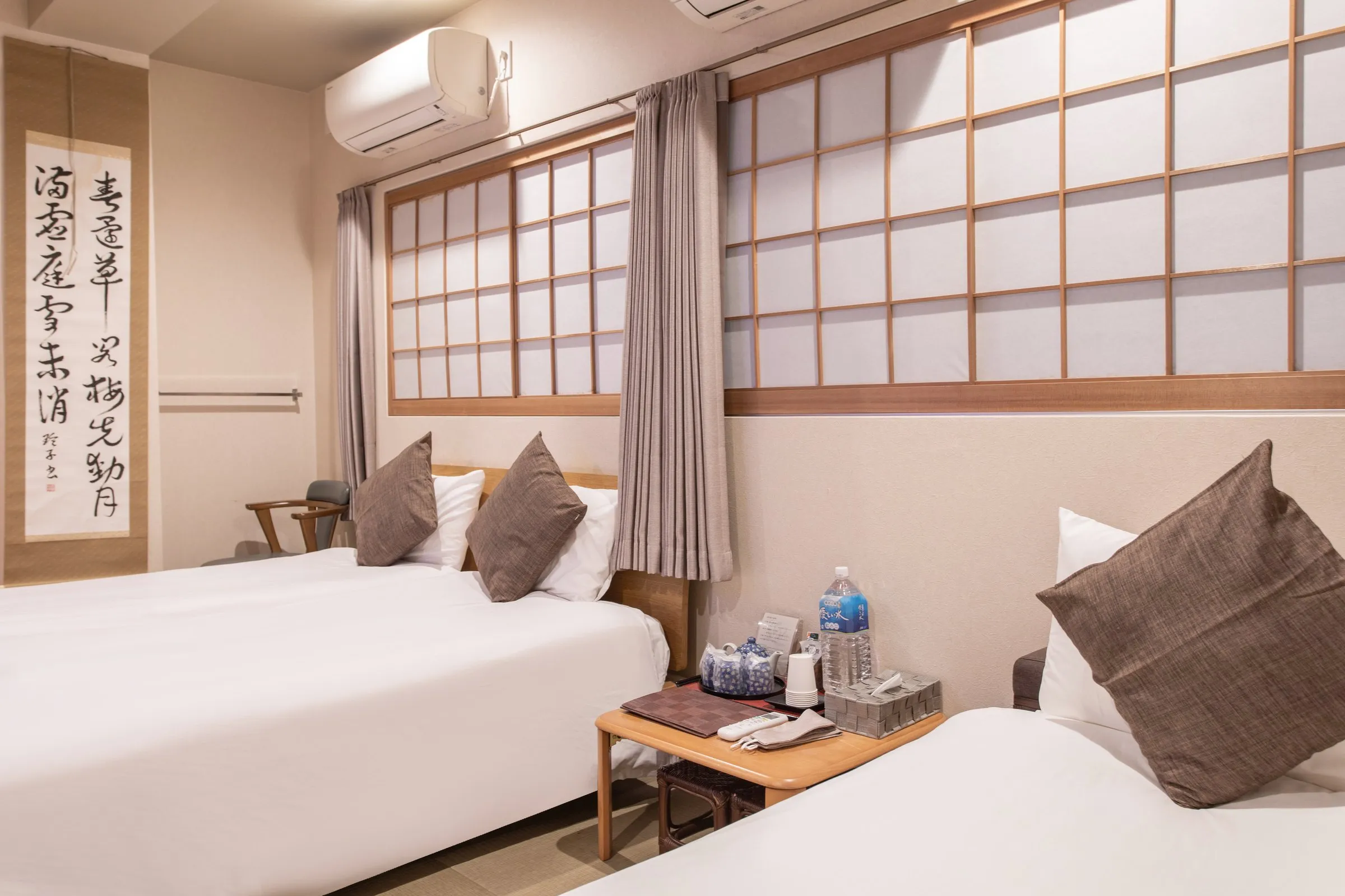 Twin room with shoji screens and a calligraphy scroll